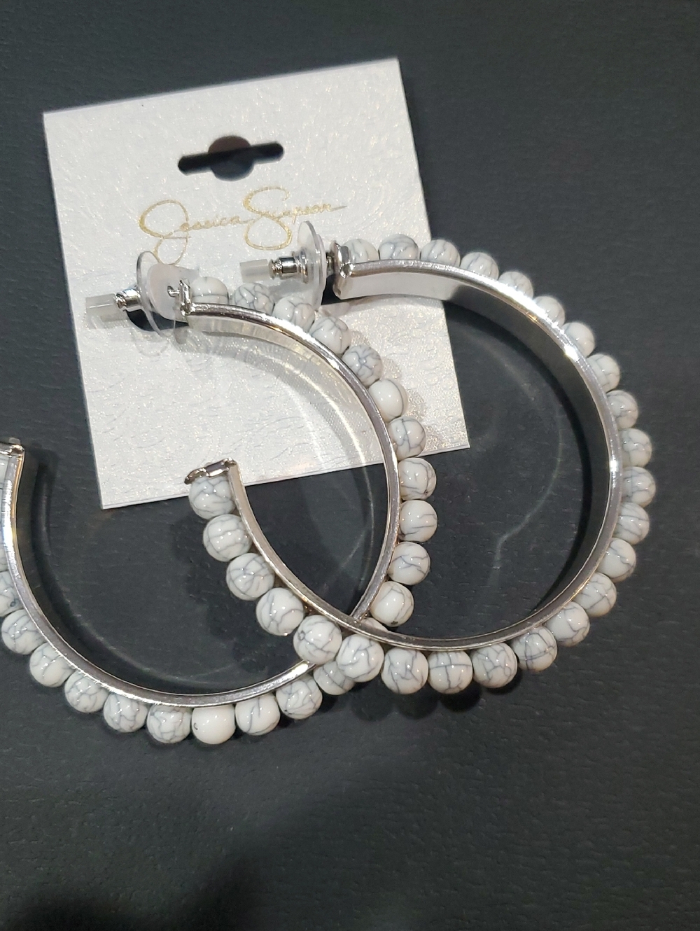 Jessica Simpson silver tone white and gray swirl orb adorned half hoop earrings